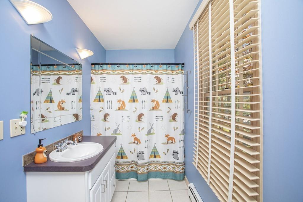 50 Lady Slipper Road Bridgewater, MA 02324 - Photo 29 of 37 a bathroom with a sink a toilet and shower curtain