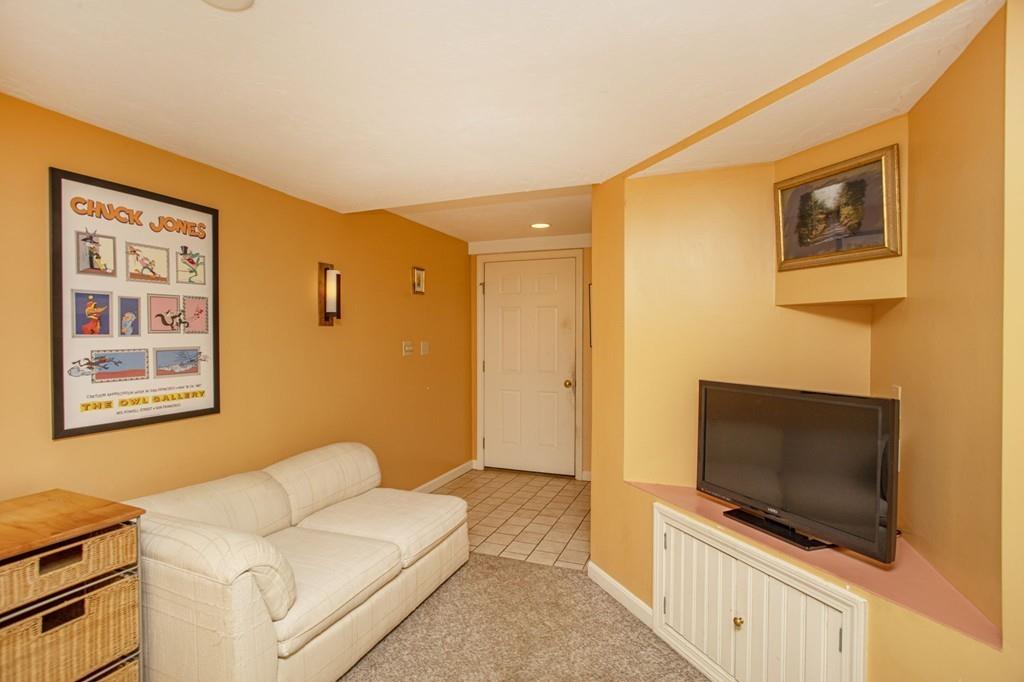 50 Lady Slipper Road Bridgewater, MA 02324 - Photo 30 of 37 a living room with a flat screen tv and a couch