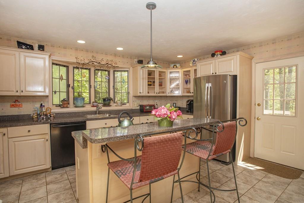50 Lady Slipper Road Bridgewater, MA 02324 - Photo 7 of 37 a kitchen that has a lot of cabinets a island in it and appliances