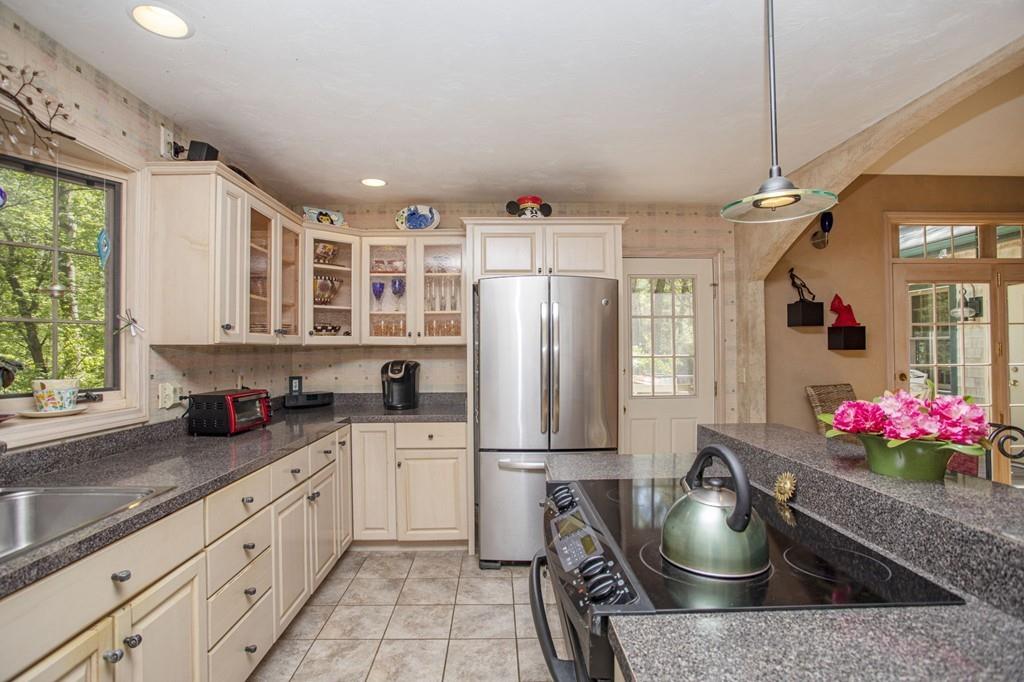 50 Lady Slipper Road Bridgewater, MA 02324 - Photo 8 of 37 a kitchen with stainless steel appliances granite countertop a sink stove and refrigerator