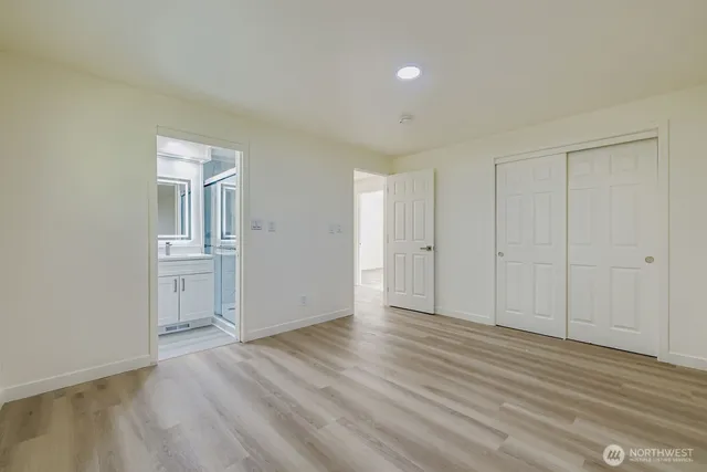 a view of an empty room and wooden floor