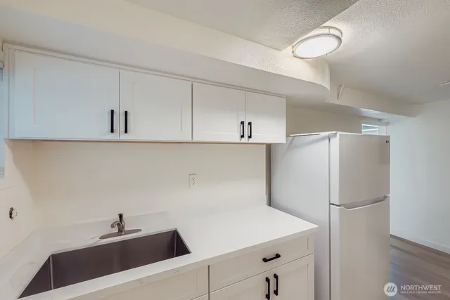 a kitchen with a refrigerator and cabinets