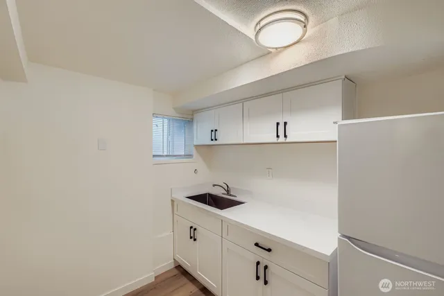 a kitchen with cabinets and a stove