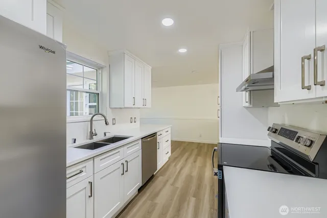a kitchen with a sink stove and cabinets