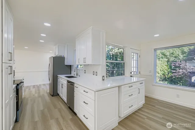 a kitchen with a sink stove and refrigerator