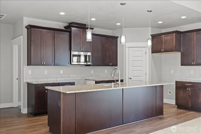 a kitchen with a sink a cabinets and stainless steel appliances