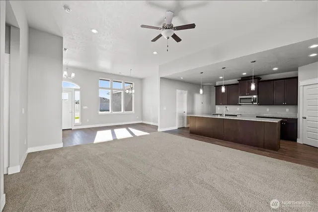 a large kitchen with stainless steel appliances kitchen island a large counter space a sink stainless steel appliances and cabinets