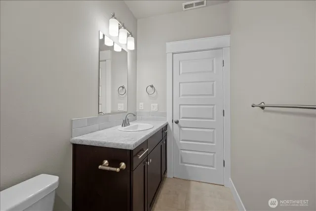 a bathroom with a sink a vanity and a mirror