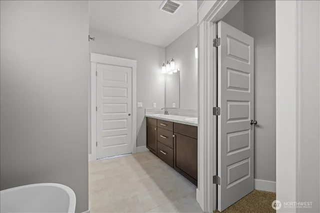 a bathroom with a granite countertop sink mirror and toilet