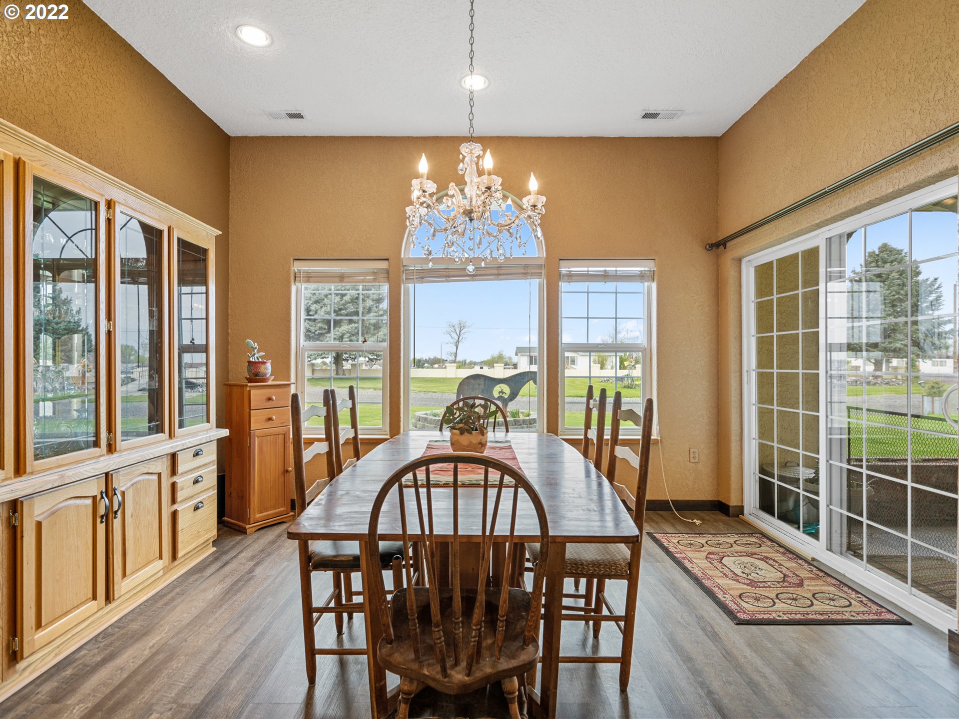 1630 North Townsend Road Hermiston, OR 97838 - Photo 11 of 24 a view of a dining room with furniture a chandelier and wooden floor