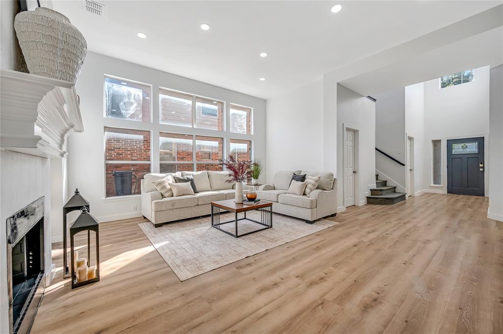 4609 Forest Park Road Plano, TX 75024 - Photo 11 of 24 Living area featuring a high end fireplace, stairway, recessed lighting, light wood-style floors, and a towering ceiling