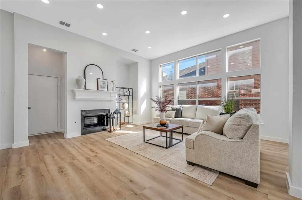 4609 Forest Park Road Plano, TX 75024 - Photo 13 of 24 Living area with a glass covered fireplace, recessed lighting, and light wood-style flooring