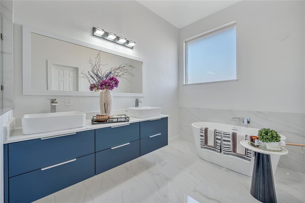 4609 Forest Park Road Plano, TX 75024 - Photo 20 of 24 Bathroom with double vanity, a freestanding bath, and light marble finish flooring
