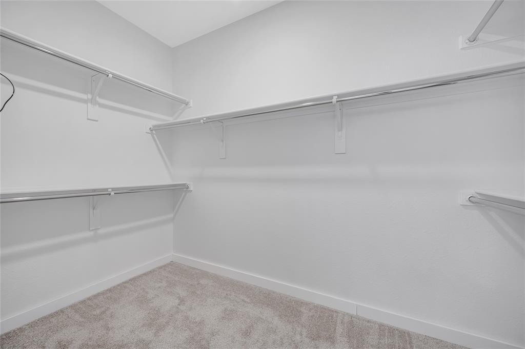 4609 Forest Park Road Plano, TX 75024 - Photo 21 of 24 Walk in closet featuring light carpet