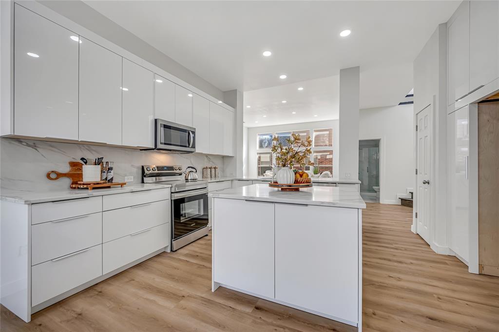 4609 Forest Park Road Plano, TX 75024 - Photo 7 of 24 Kitchen featuring stainless steel appliances, modern cabinets, white cabinetry, light wood-style floors, and recessed lighting