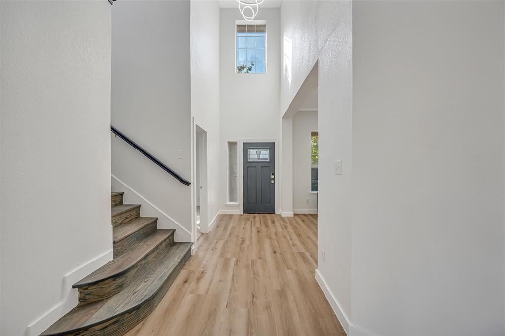4609 Forest Park Road Plano, TX 75024 - Photo 10 of 24 Entryway with light wood finished floors, stairway, and a high ceiling