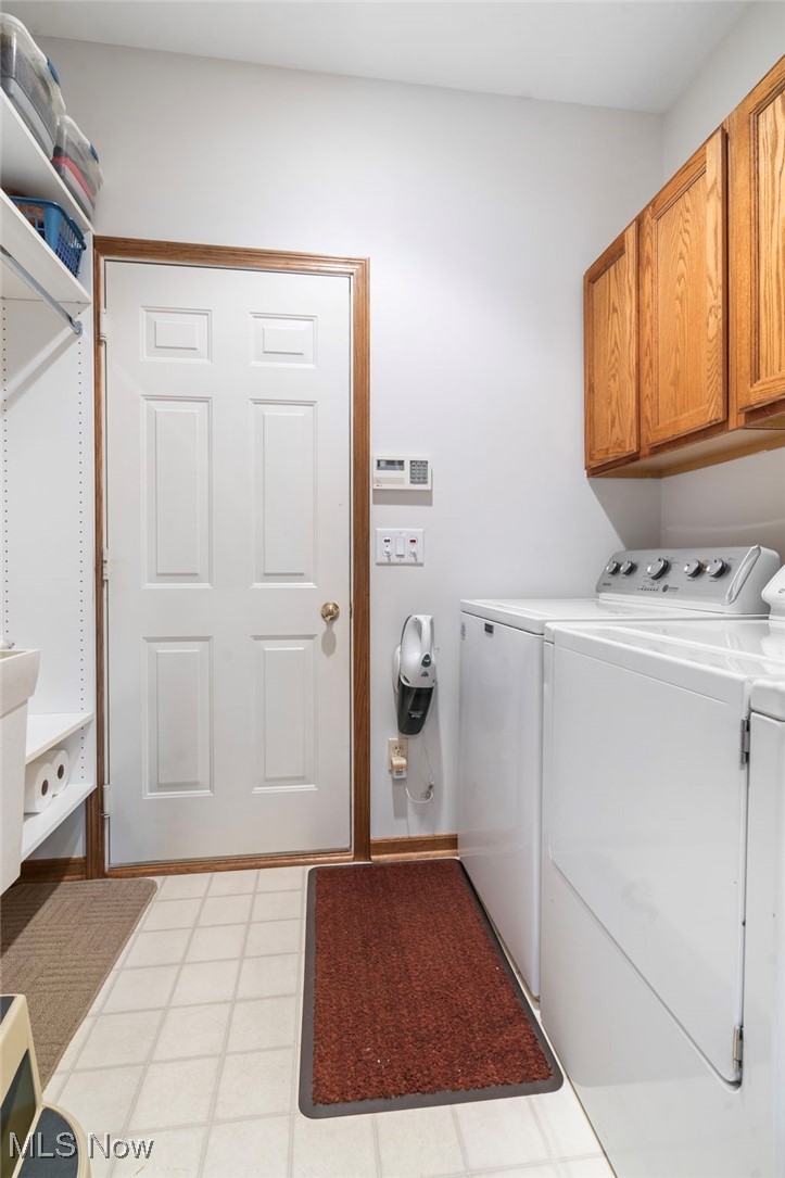 2503 Charing Cross Road Northwest Canton, OH 44708 - Photo 26 of 30 Clothes washing area with light tile patterned flooring, separate washer and dryer, and cabinets