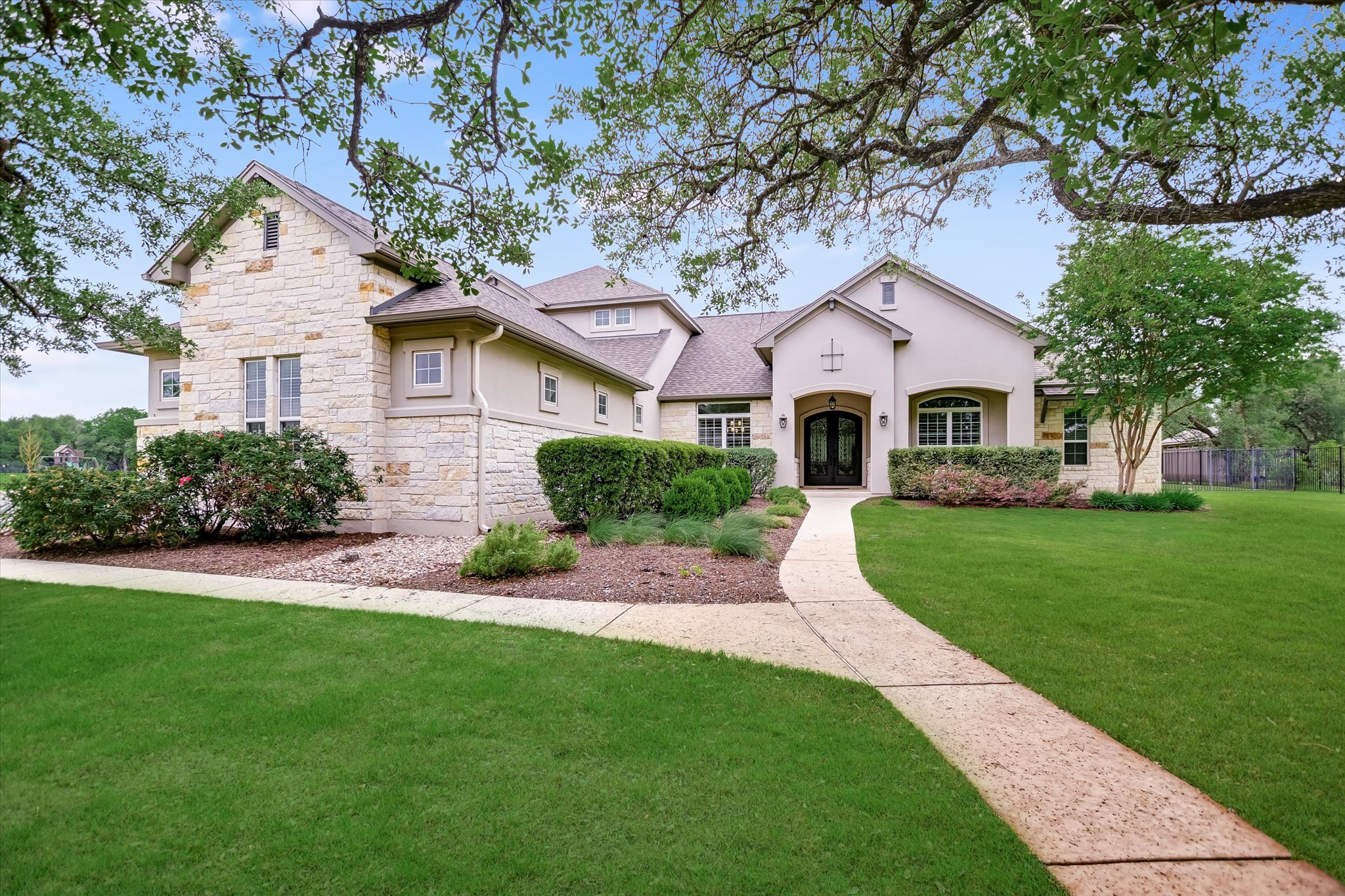 2561 Ridley House Cove Leander, TX 78641 - Photo 1 of 36 Stone and stucco exterior featuring a double-door entry with arched transom
