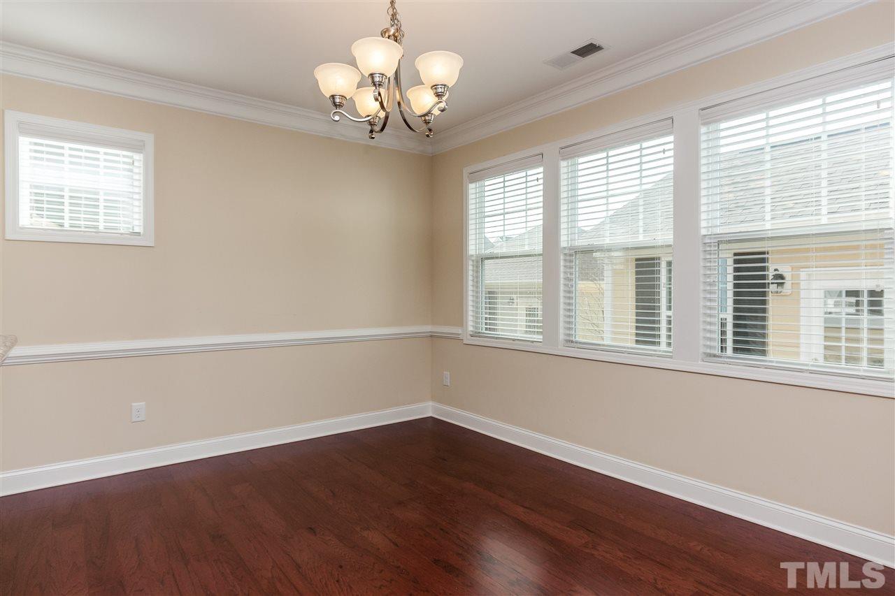 1553 Fullerton Place Raleigh, NC 27607 - Photo 11 of 25 a view of an empty room with wooden floor and a window