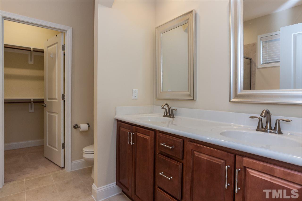 1553 Fullerton Place Raleigh, NC 27607 - Photo 17 of 25 a bathroom with a sink and a mirror