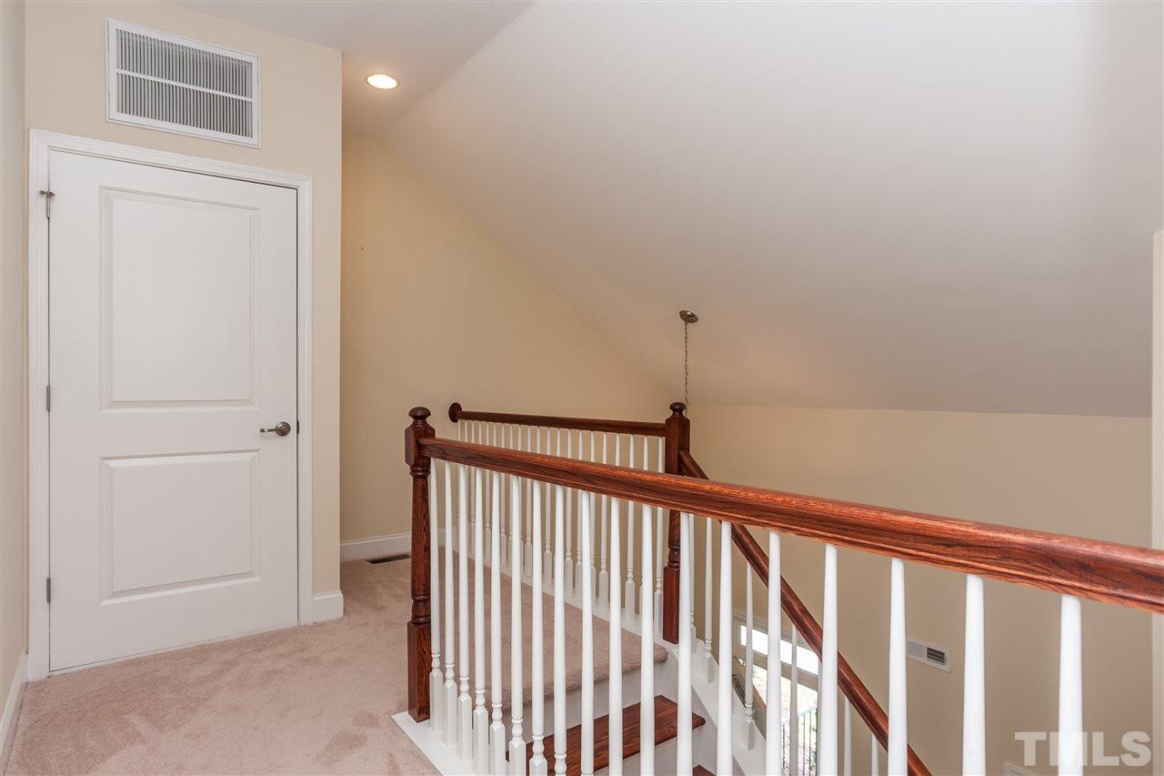 1553 Fullerton Place Raleigh, NC 27607 - Photo 19 of 25 a view of a hallway with wooden floor and a bathroom