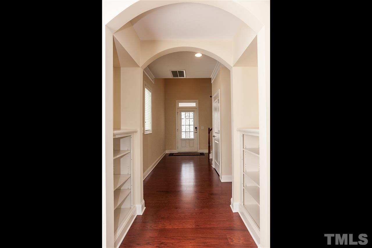 1553 Fullerton Place Raleigh, NC 27607 - Photo 3 of 25 a view of a hallway with wooden floor