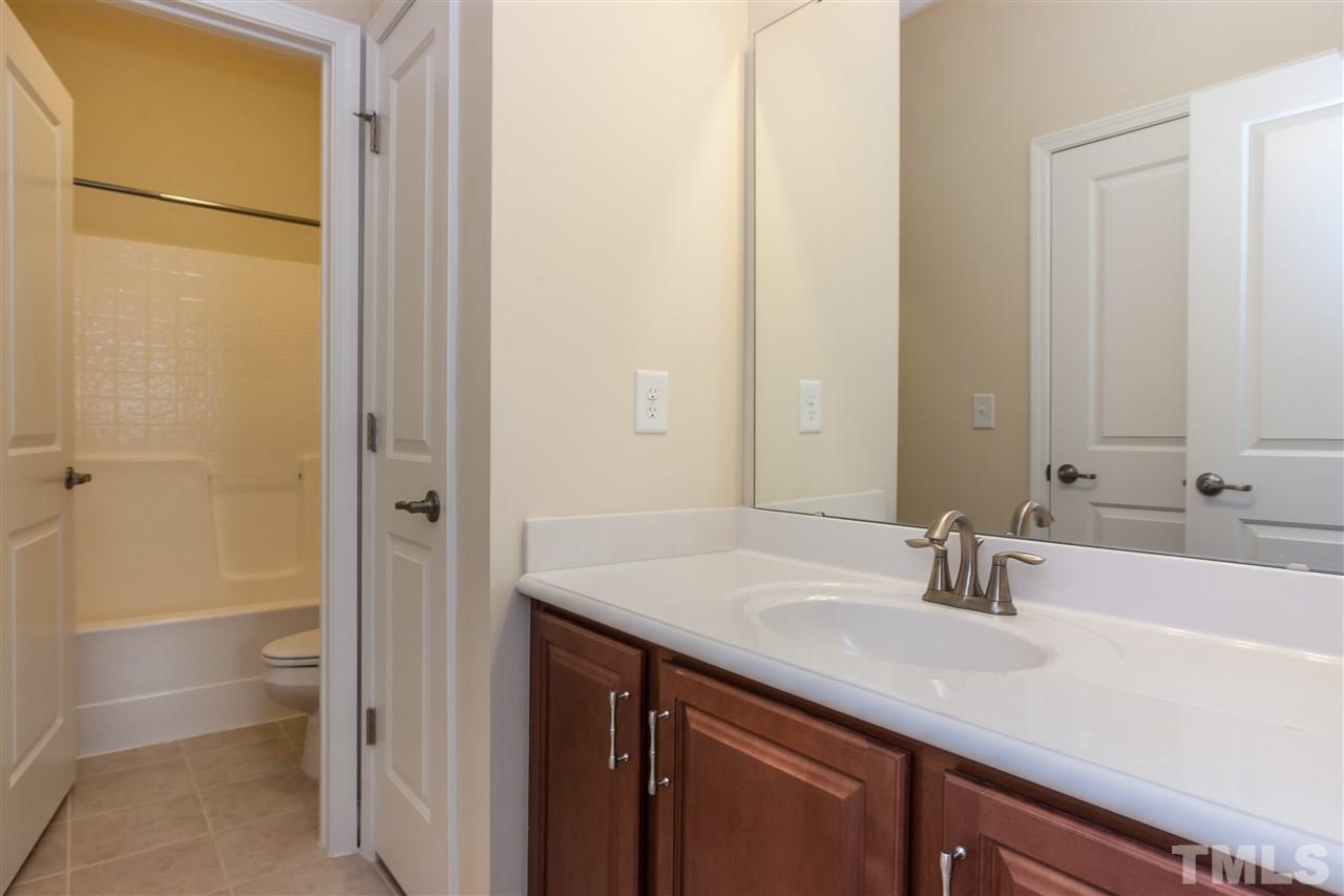1553 Fullerton Place Raleigh, NC 27607 - Photo 22 of 25 a bathroom with a sink and a mirror