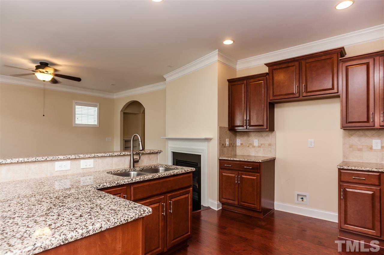 1553 Fullerton Place Raleigh, NC 27607 - Photo 10 of 25 a kitchen with stainless steel appliances granite countertop a stove a sink and a refrigerator