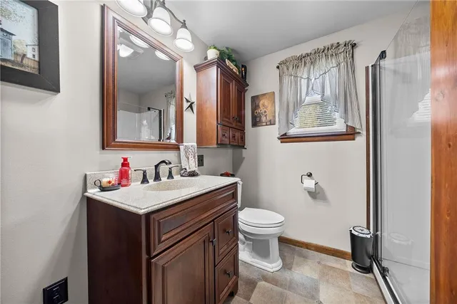 a bathroom with a sink toilet and a mirror