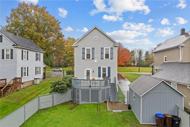 a table and chairs in front of a house