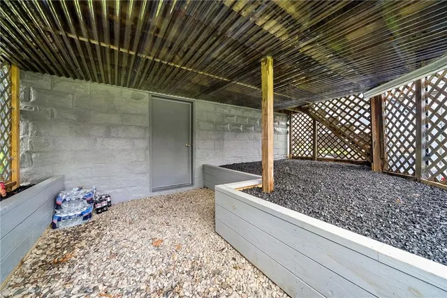 a view of a house with a big yard and large trees