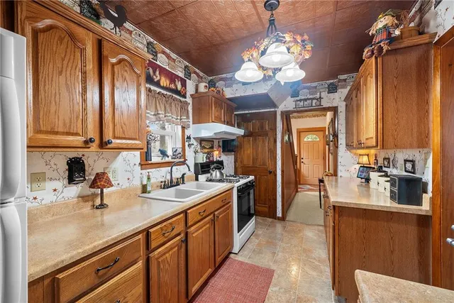 a kitchen with a sink stove and cabinets