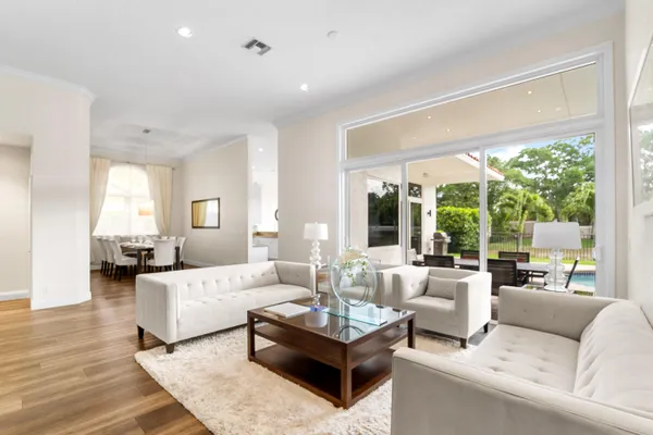 a living room with furniture and a wooden floor