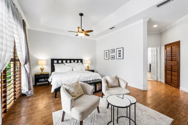 a bedroom with a bed furniture and a flat screen tv