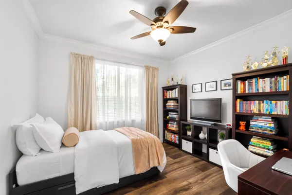 a bedroom with a bed and a chandelier