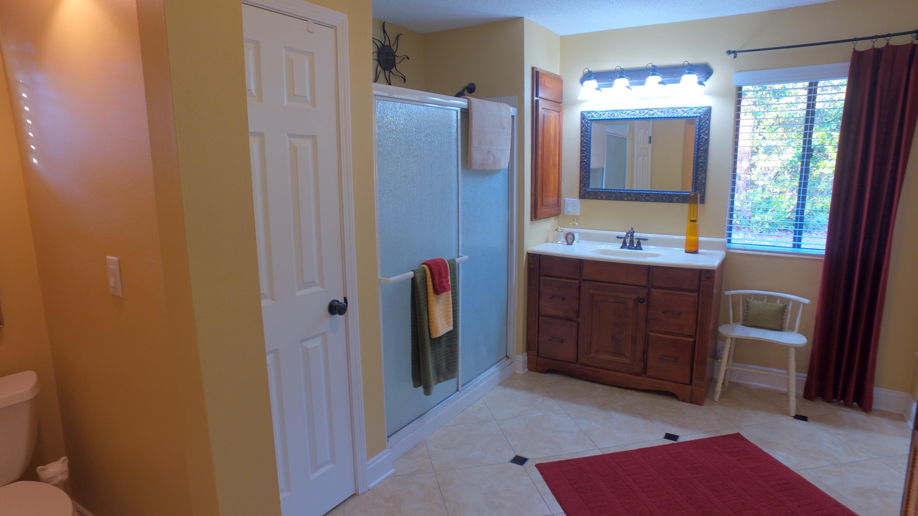 495 Ridge Lake Road Crestview, FL 32536 - Photo 21 of 26 a bathroom with a double vanity sink and mirror with shower