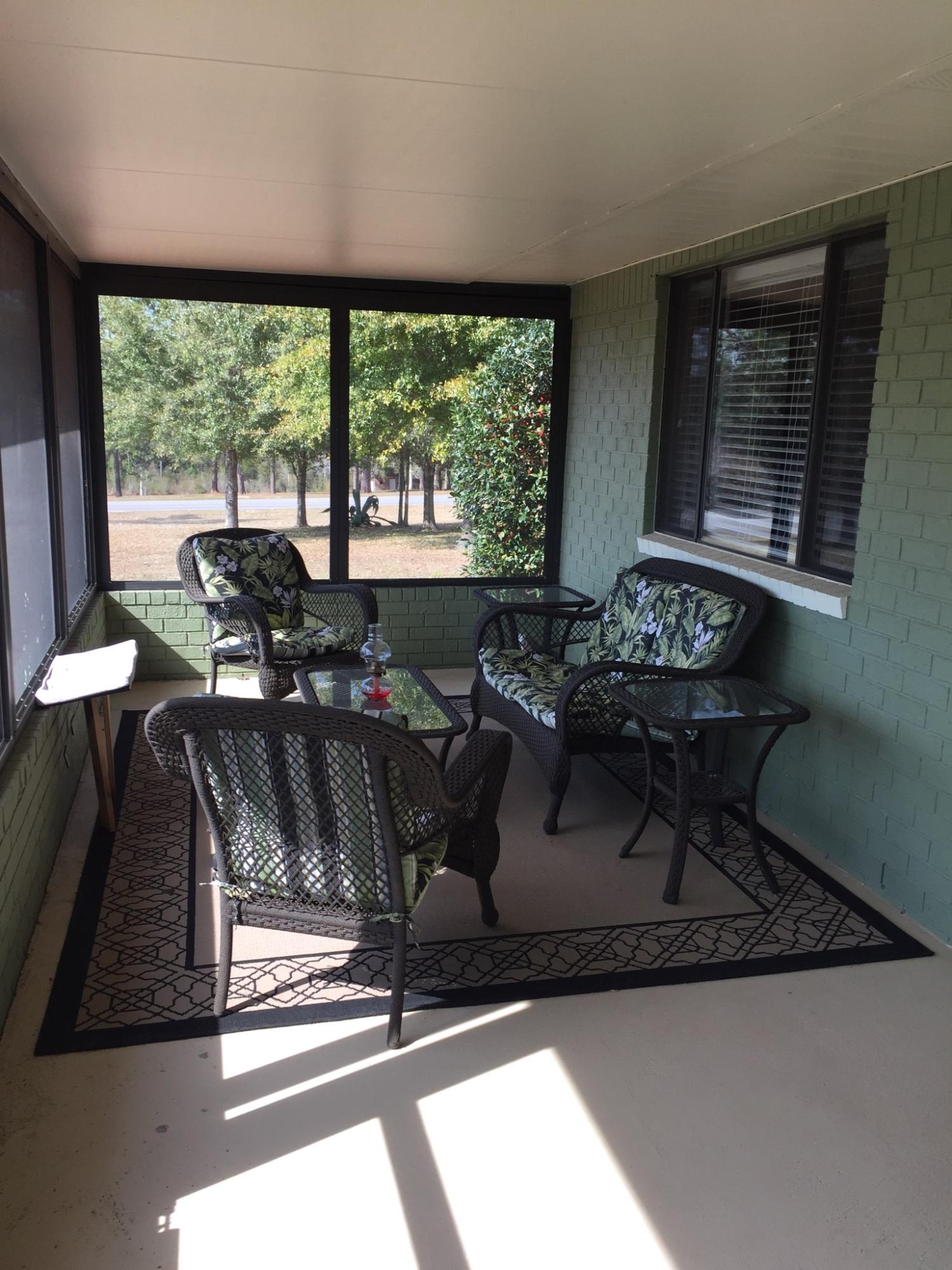 495 Ridge Lake Road Crestview, FL 32536 - Photo 8 of 26 a living room with furniture and a floor to ceiling window