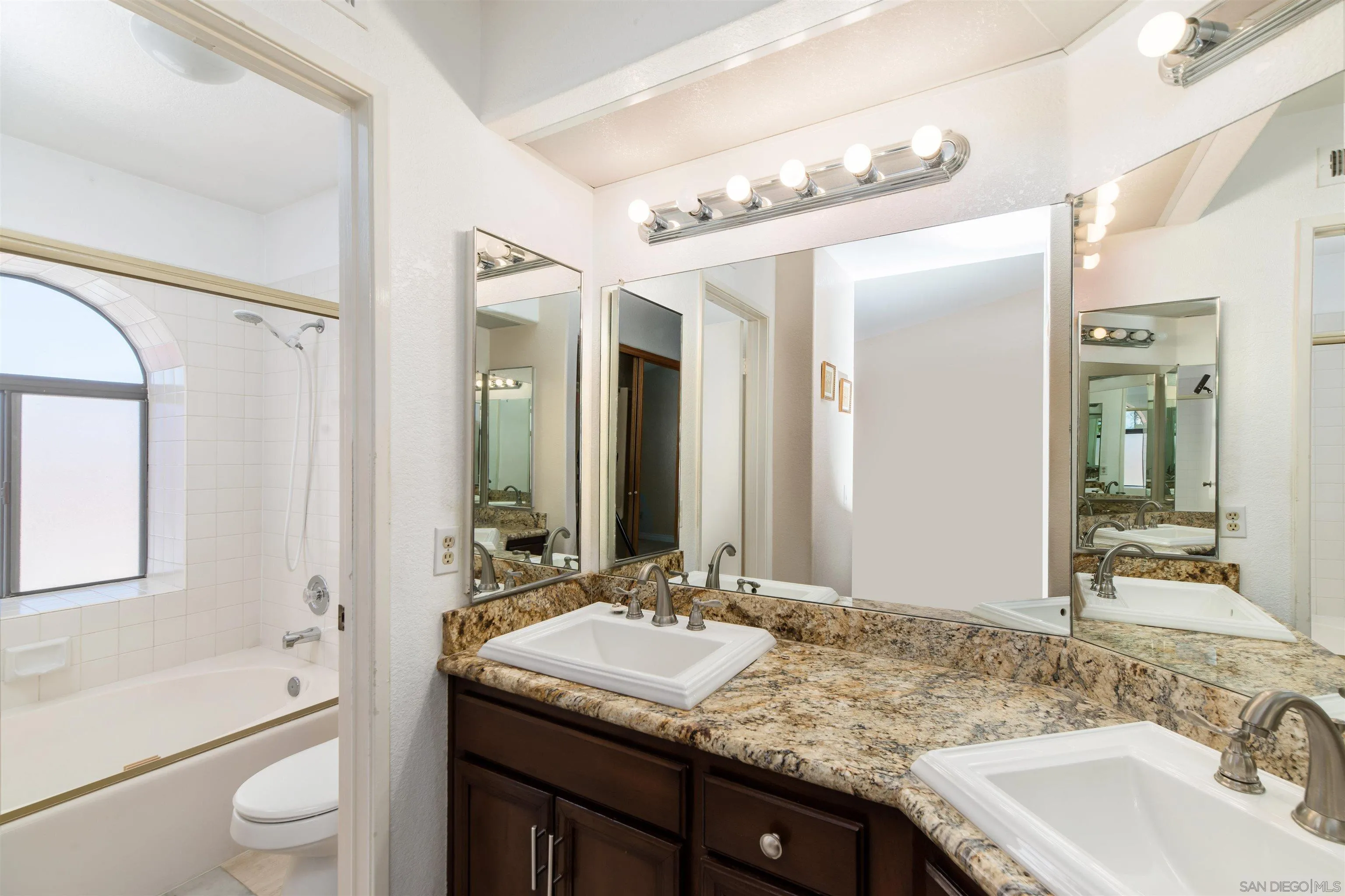12810 Cochera Road Lakeside, CA 92040 - Photo 11 of 19 a bathroom with a granite countertop sink double vanity granite tub shower and a mirror