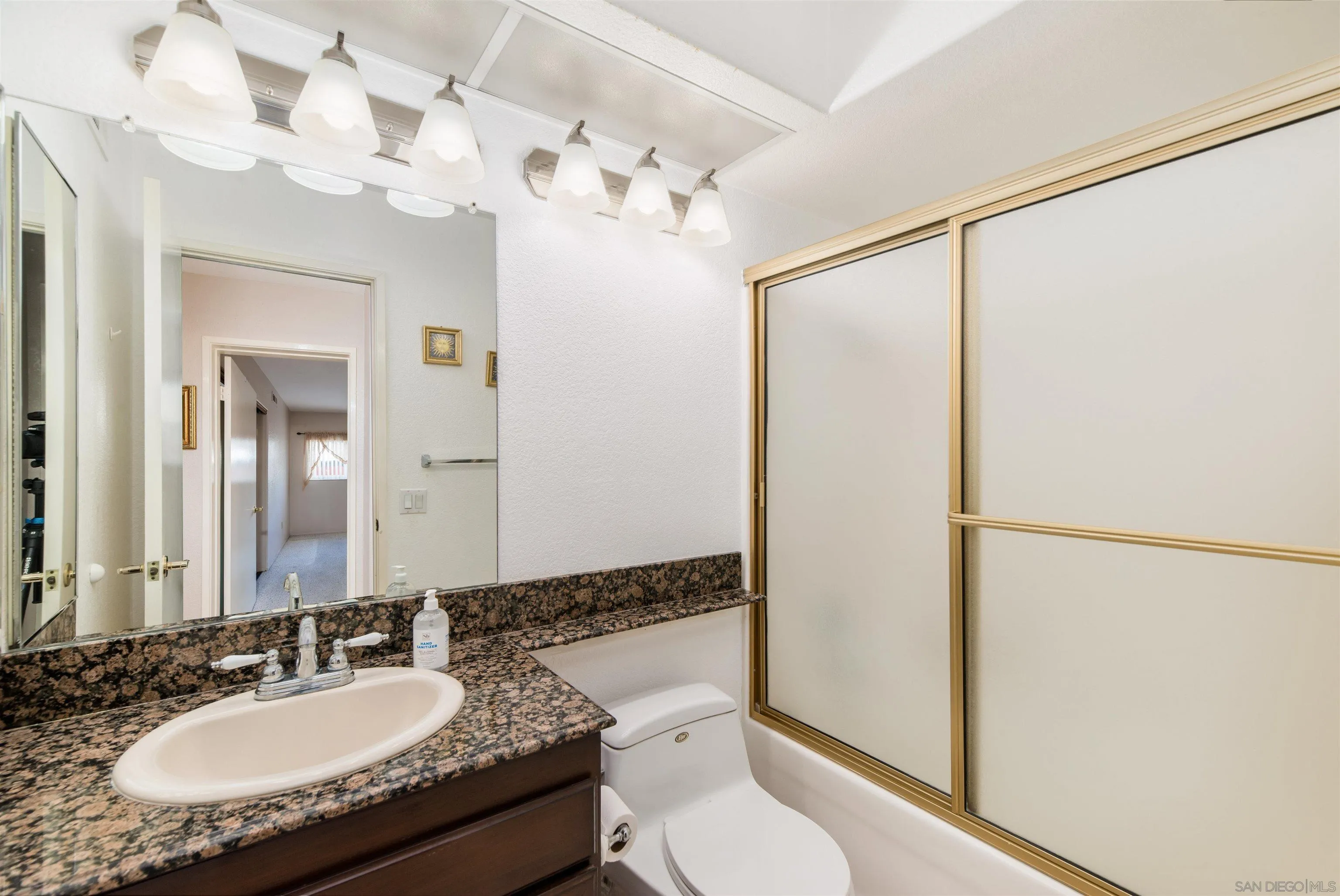 12810 Cochera Road Lakeside, CA 92040 - Photo 13 of 19 a bathroom with a granite countertop sink mirror vanity and toilet