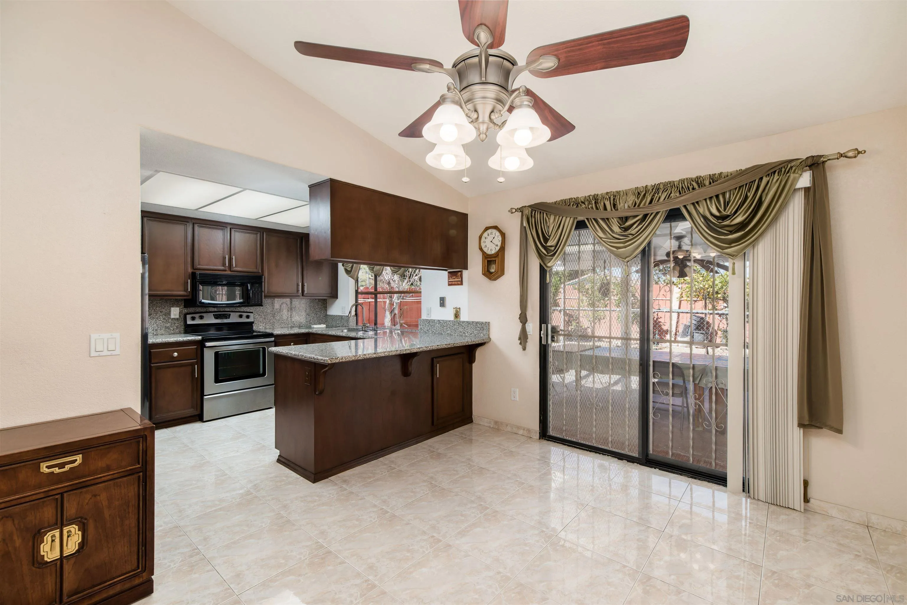 12810 Cochera Road Lakeside, CA 92040 - Photo 7 of 19 a open kitchen with stainless steel appliances granite countertop a refrigerator a stove a sink and a microwave