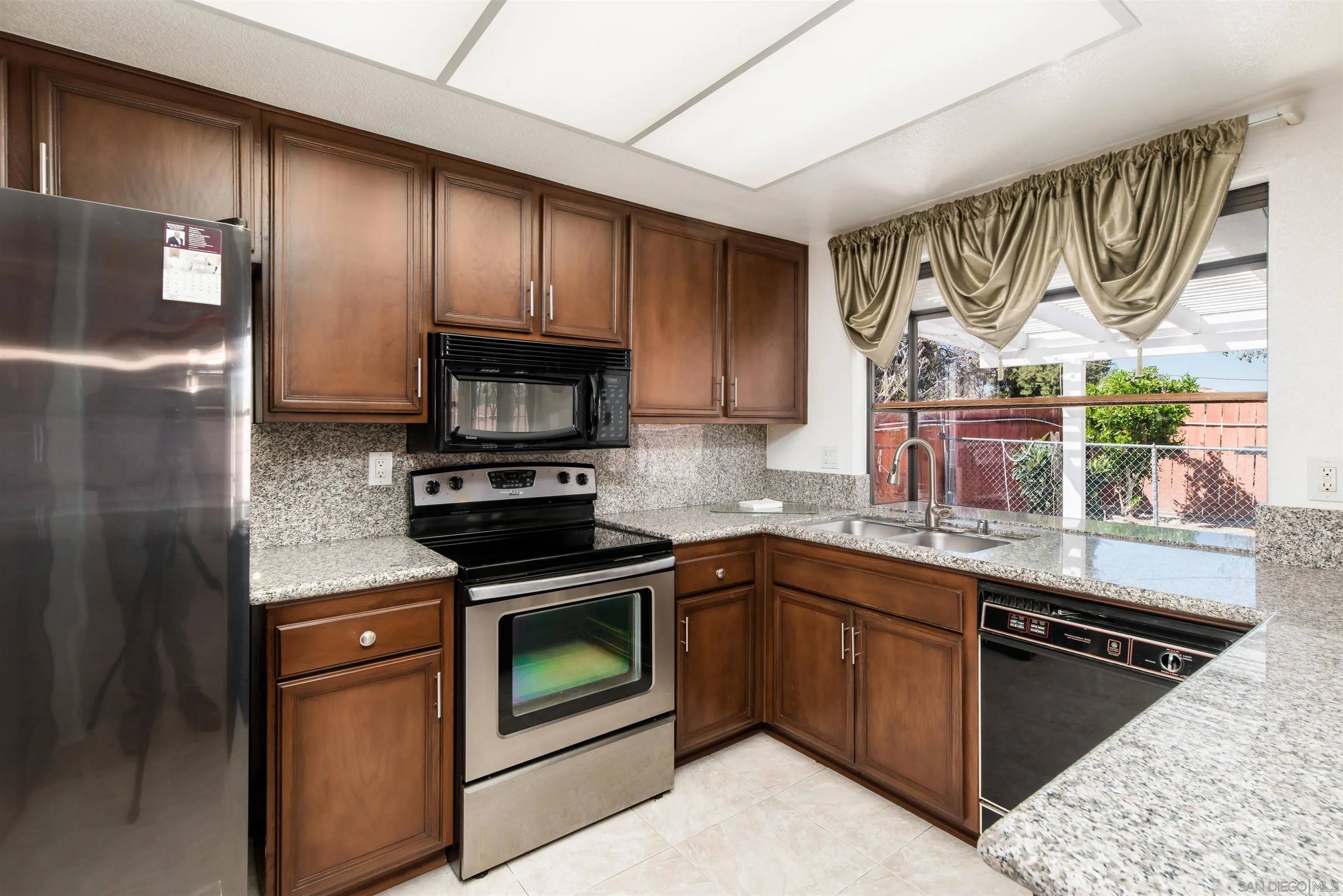 12810 Cochera Road Lakeside, CA 92040 - Photo 8 of 19 a kitchen with a sink stove and refrigerator