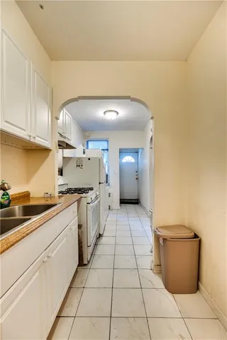 a kitchen with a sink a stove and cabinets