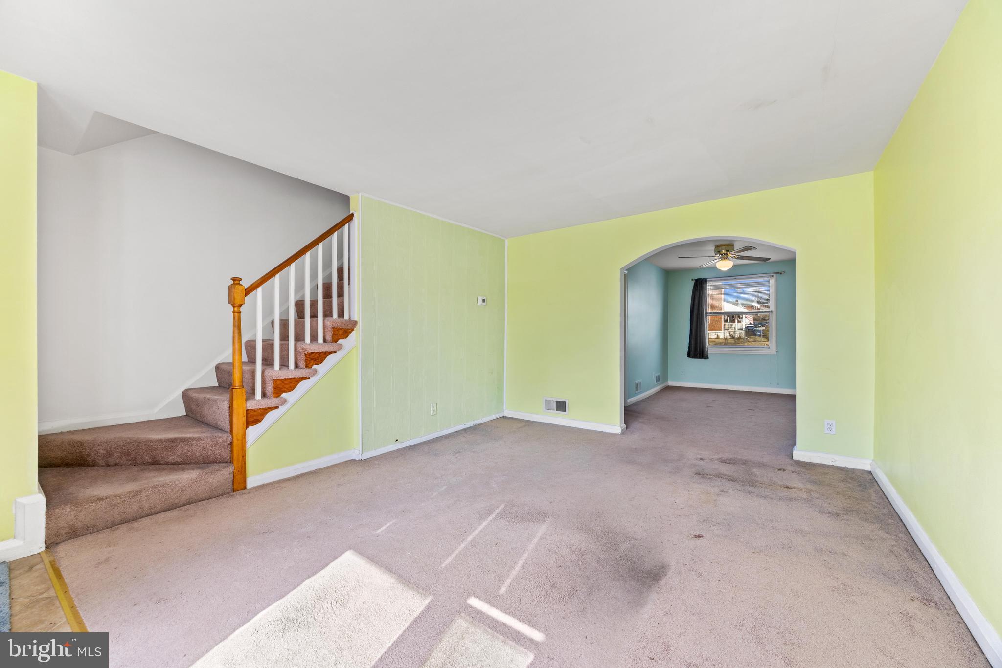 7310 Kirtley Road Baltimore, MD 21224 - Photo 4 of 31 a view of an empty room with window and stairs