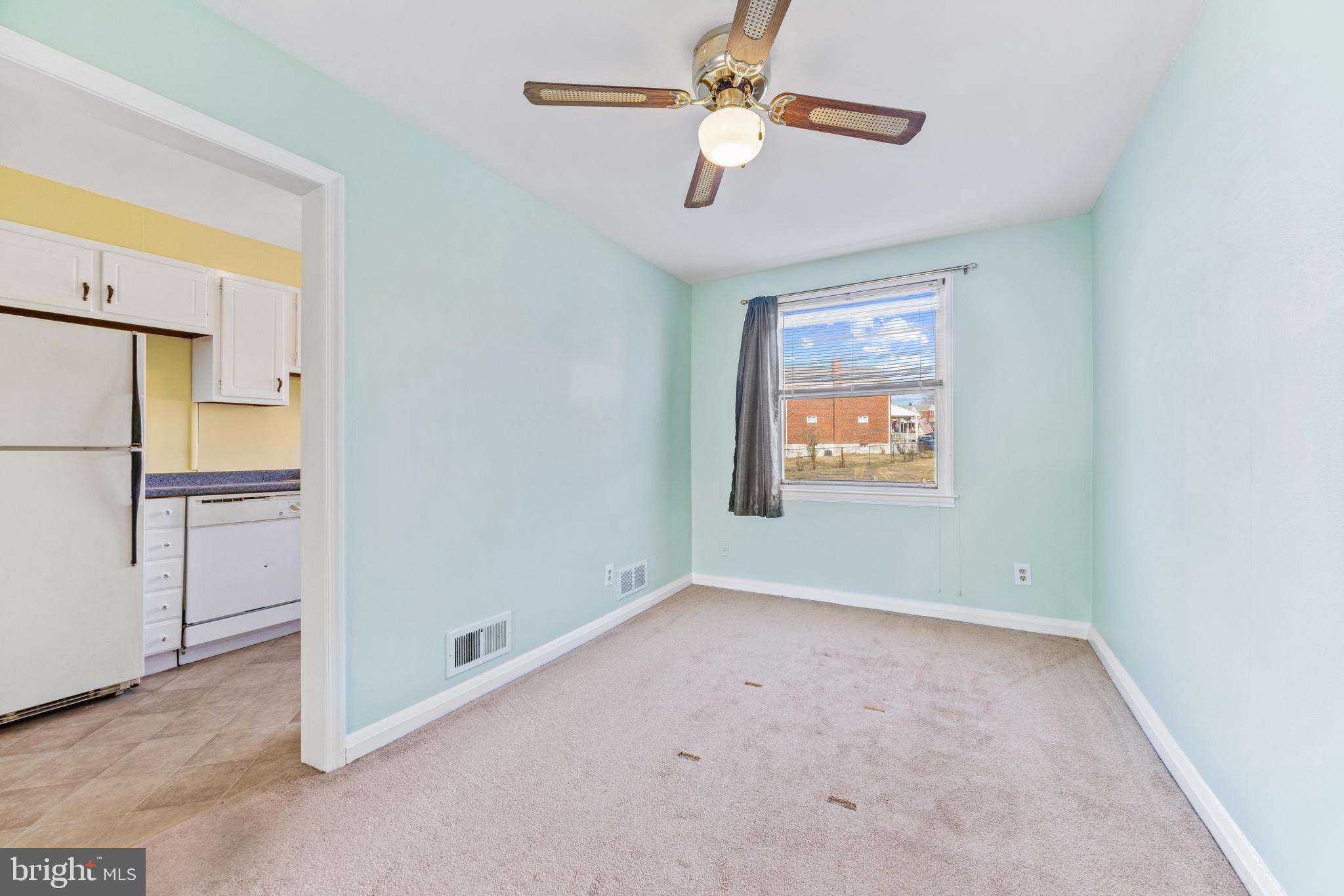 7310 Kirtley Road Baltimore, MD 21224 - Photo 8 of 31 an empty room with a ceiling fan and a window