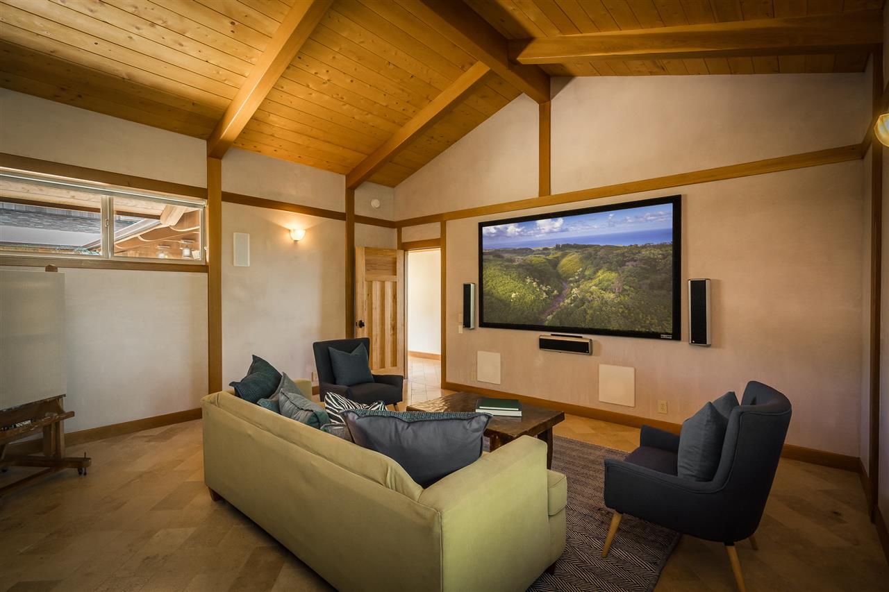 770 North Honokala Road, Unit A Haiku, HI 96708 - Photo 14 of 30 a living room with furniture and a flat screen tv