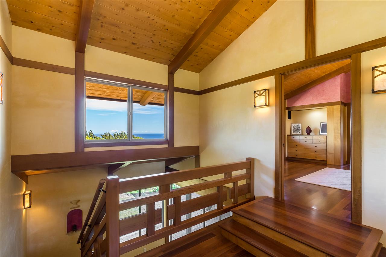 770 North Honokala Road, Unit A Haiku, HI 96708 - Photo 20 of 30 a view of a hallway with wooden floor and door