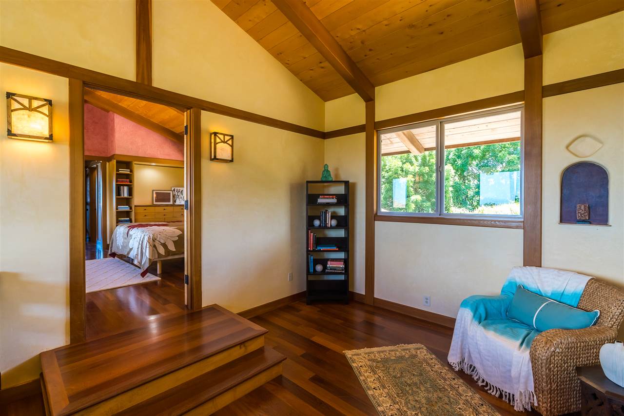 770 North Honokala Road, Unit A Haiku, HI 96708 - Photo 21 of 30 a bedroom with a bed and wooden floor