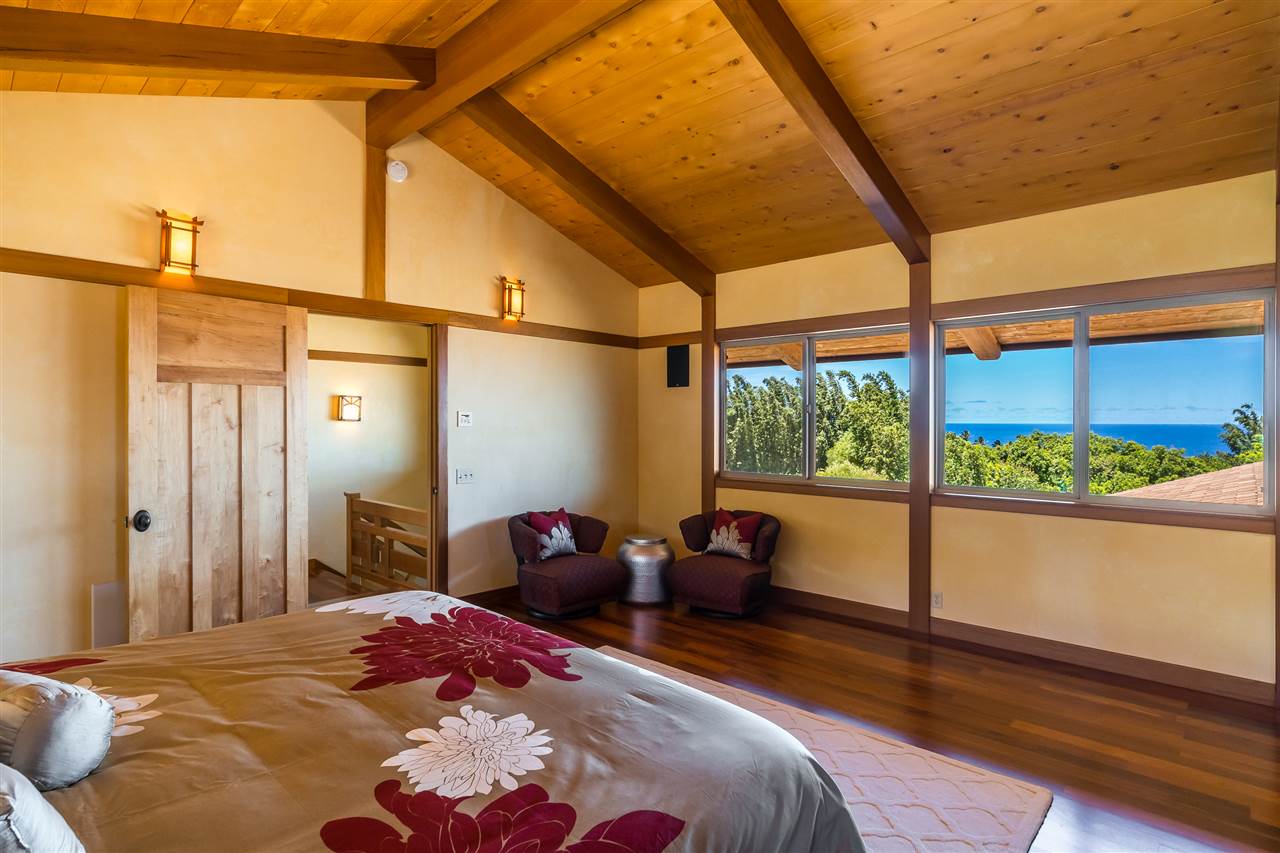 770 North Honokala Road, Unit A Haiku, HI 96708 - Photo 23 of 30 a bedroom with a bed and a large window with outer view