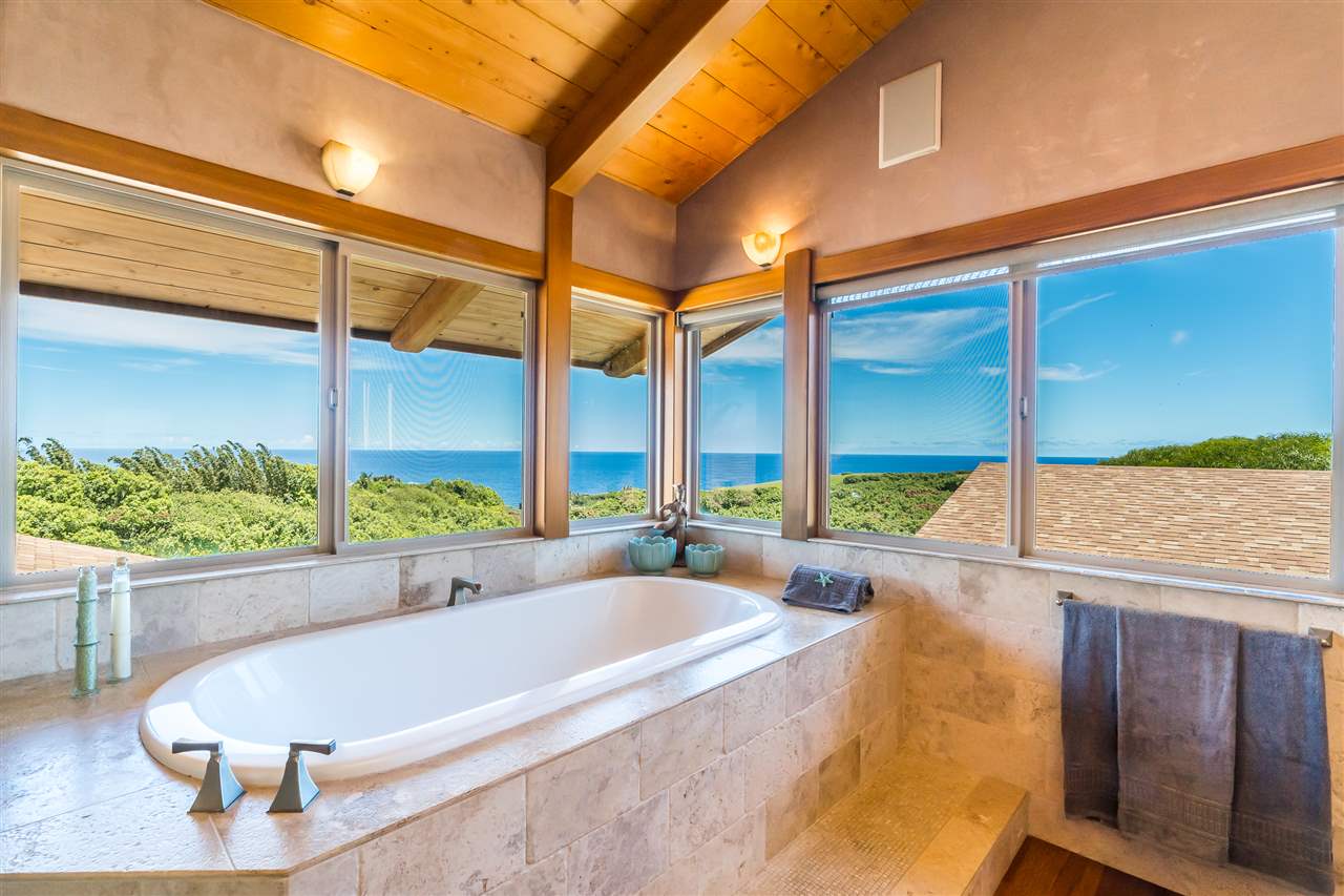 770 North Honokala Road, Unit A Haiku, HI 96708 - Photo 26 of 30 a bathroom with a tub and large window