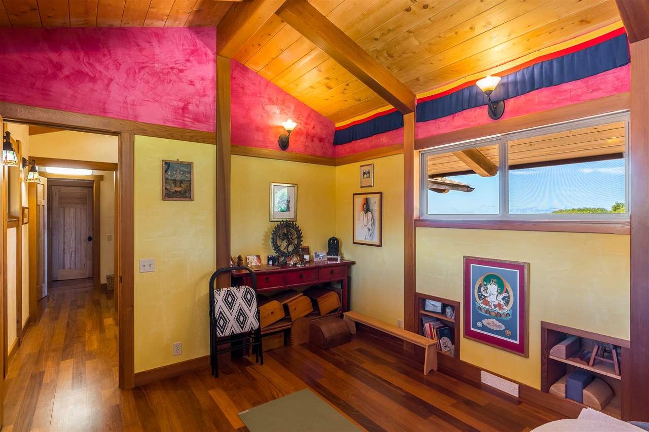 770 North Honokala Road, Unit A Haiku, HI 96708 - Photo 27 of 30 a view of a bedroom with furniture and wooden floor